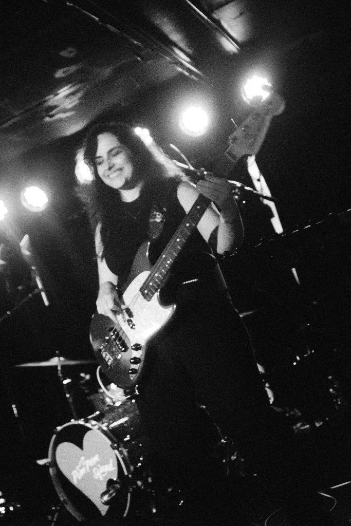 Photo of Lauren Marquez playing bass guitar.